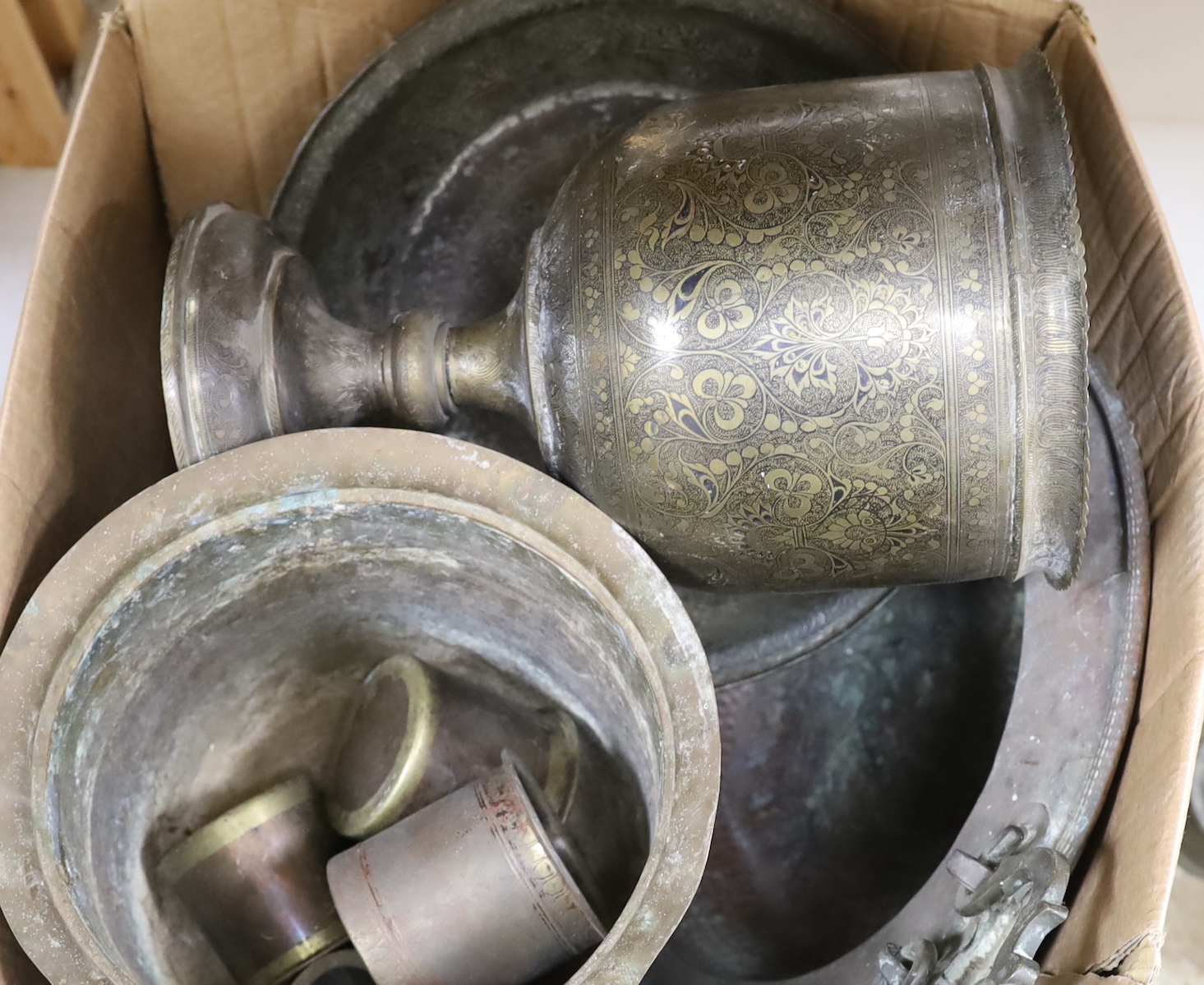 A group of 19th and early 20th century Indian brass and copper vessels, dishes, a vase, measures, etc. largest dish 46.5cm diameter